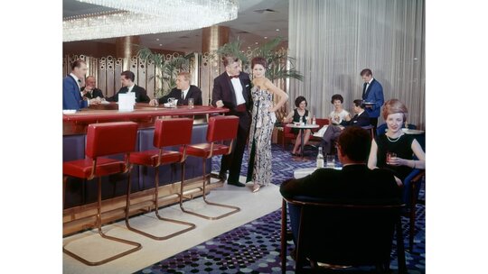 The deZangers would make a list of every scene they wanted to capture at each hotel, and then Wilma would source models. Often Pan Am flight attendants and pilots would step in, she says, as well as hotel employees. Here's the restaurant at the InterContinental Wien Hotel in Vienna, Austria, which opened in 1964 and is still operating today.