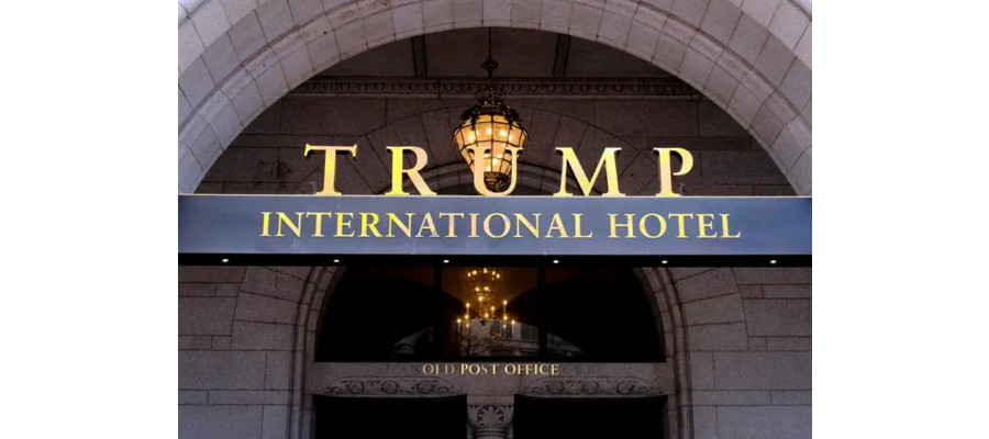 Workers began tearing down the gold letters of the Trump International Hotel's sign just hours after the sale of the DC hotel went through